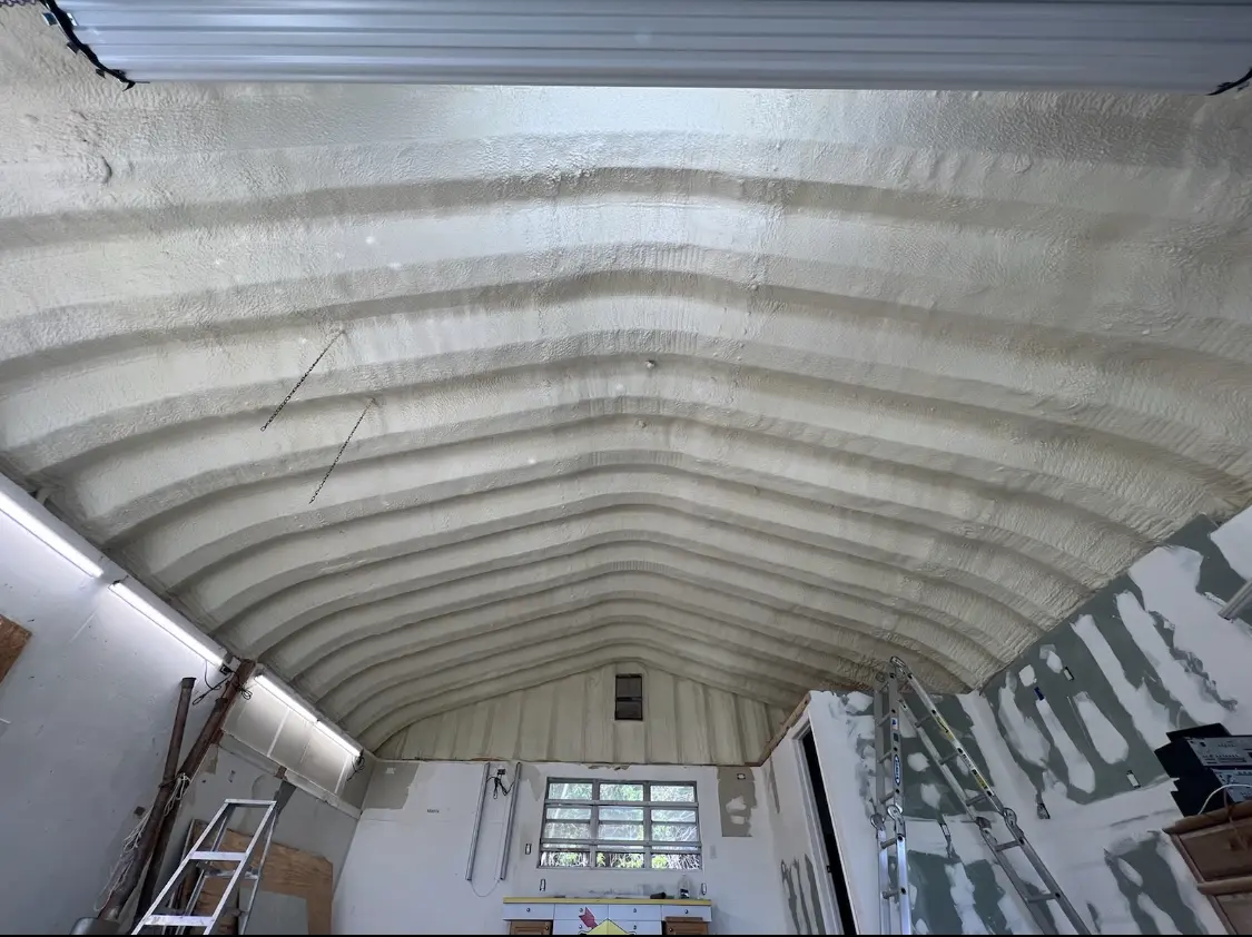 Spray polyurethane foam applied to the underside of a metal roof deck in Ames
